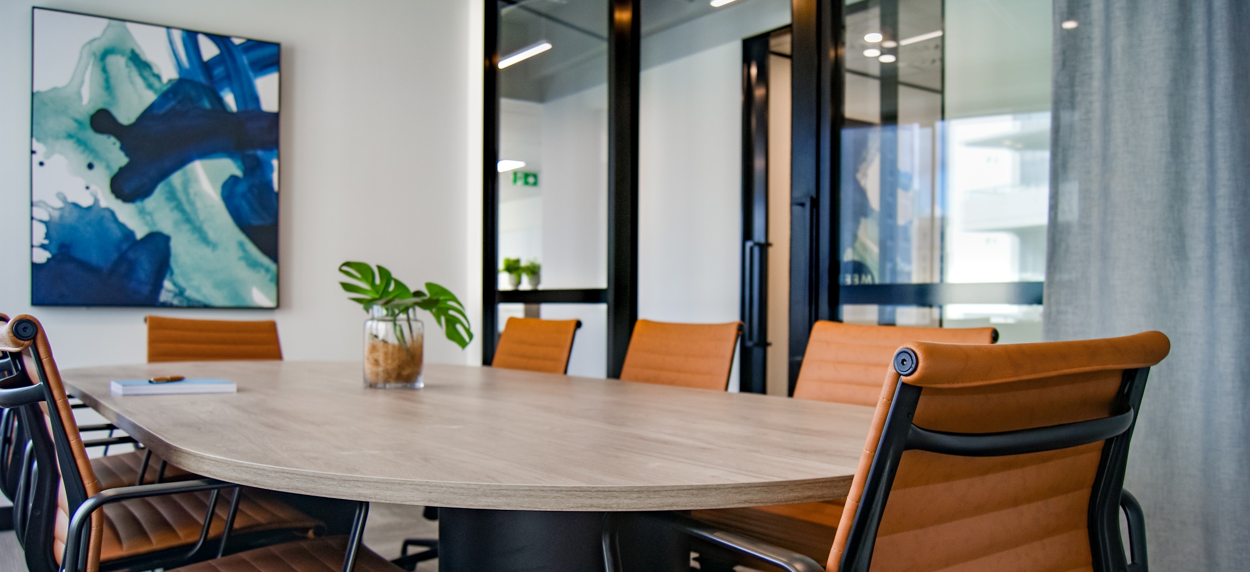 conference room with orange chairs and a blue painting